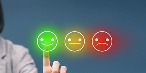 Consumer pressing satisfaction buttons to rate a brand, ranging from bad and acceptable to good